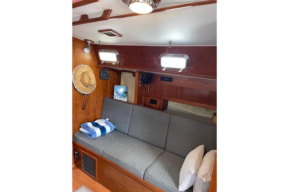 Interior of 1989 Caliber 38 sailboat with cozy seating and nautical decor.