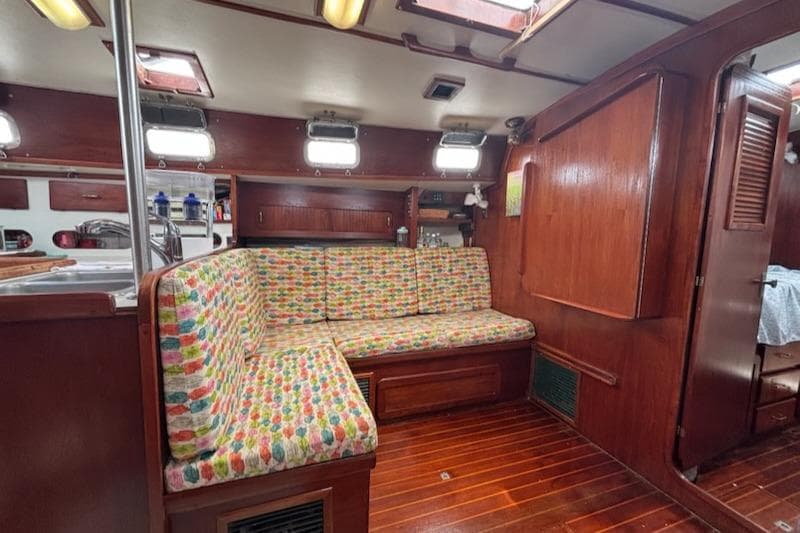Interior of 1989 Caliber 38 sailboat with colorful seating and wooden finishes.