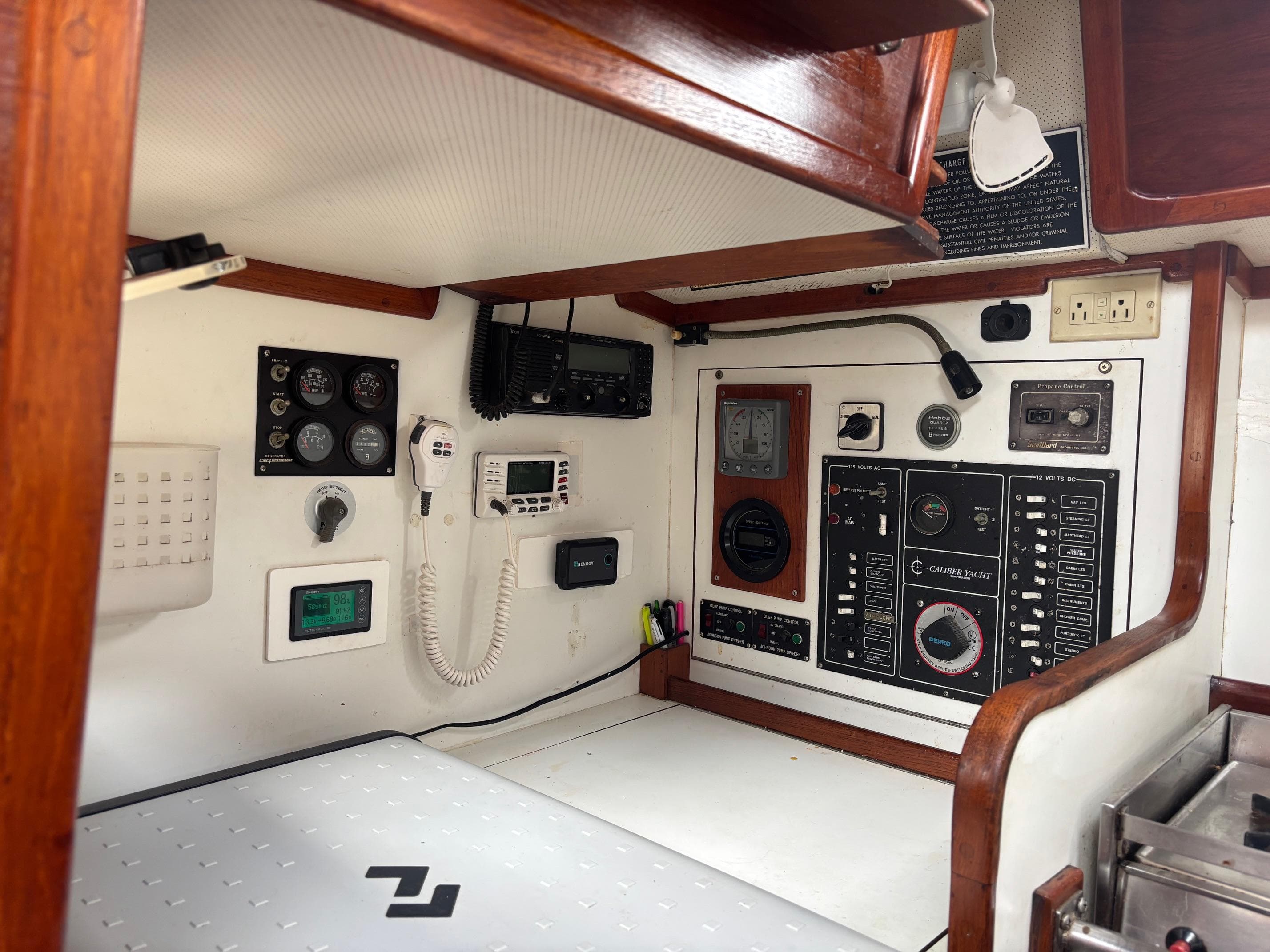 Control panel inside a 1989 Caliber 38 yacht, featuring gauges and communication equipment.