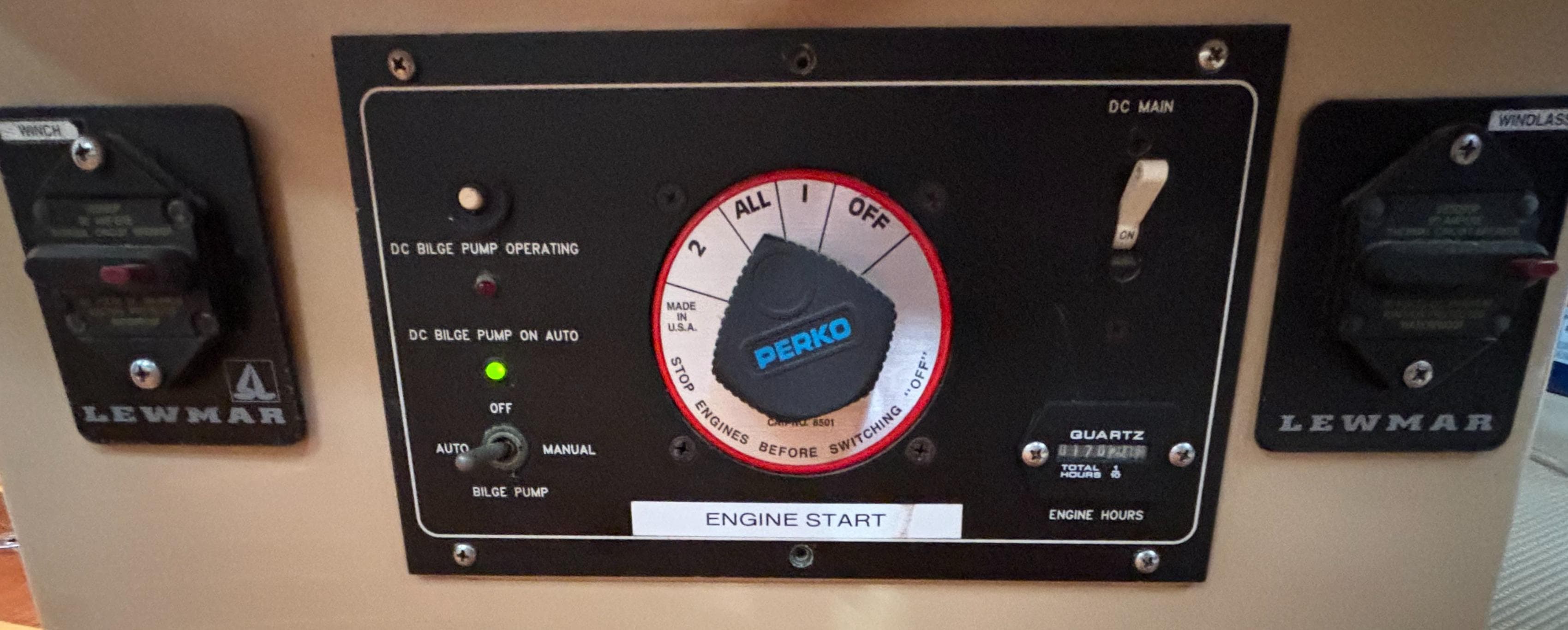 Control panel of a 1995 Island Packet 40 sailboat with Perko switch and Lewmar controls.