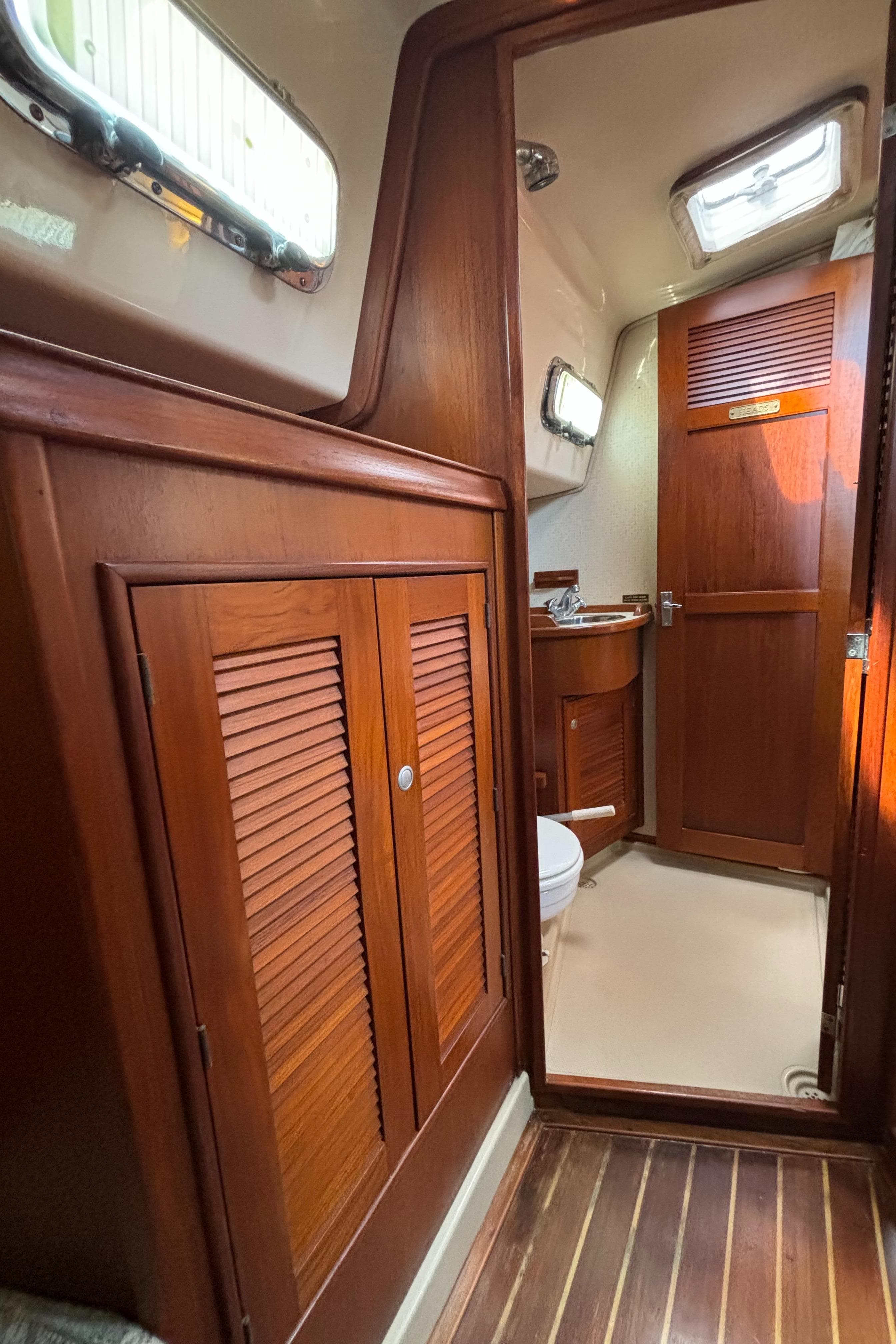 Interior of 1995 Island Packet 40 sailboat with wooden cabinetry and natural light.