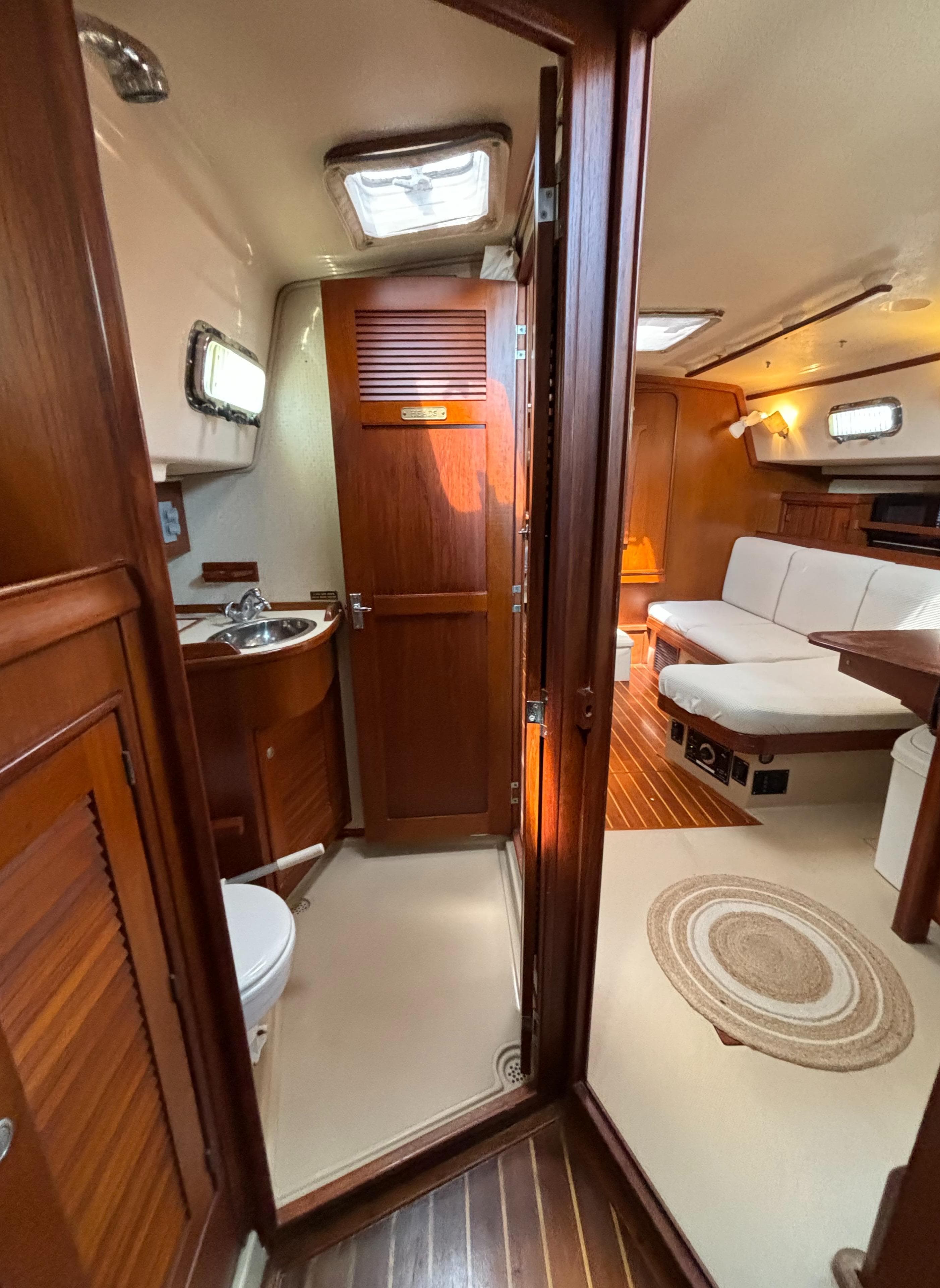Interior of a 1995 Island Packet 40 sailboat, featuring a cozy cabin and wooden finishes.