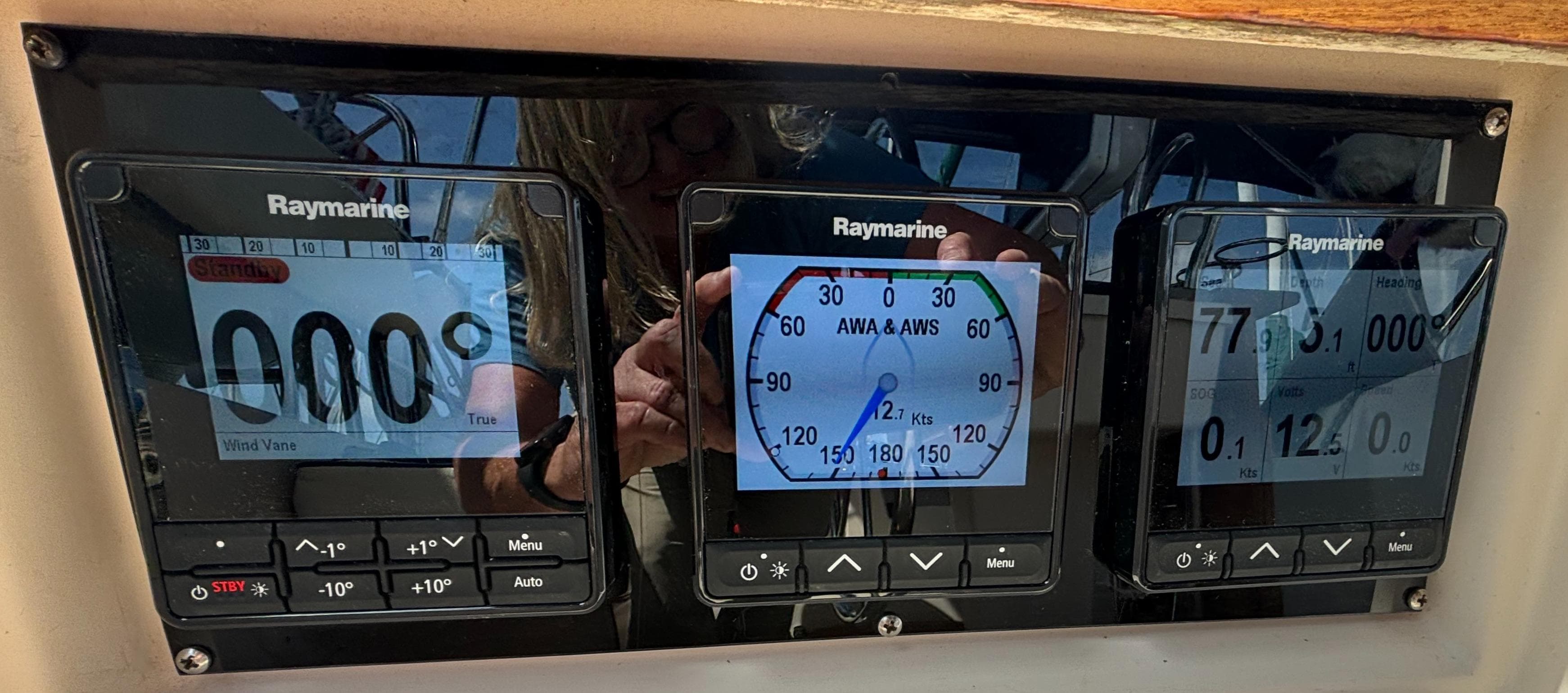 Raymarine navigation instruments on a 1995 Island Packet 40 sailboat dashboard.