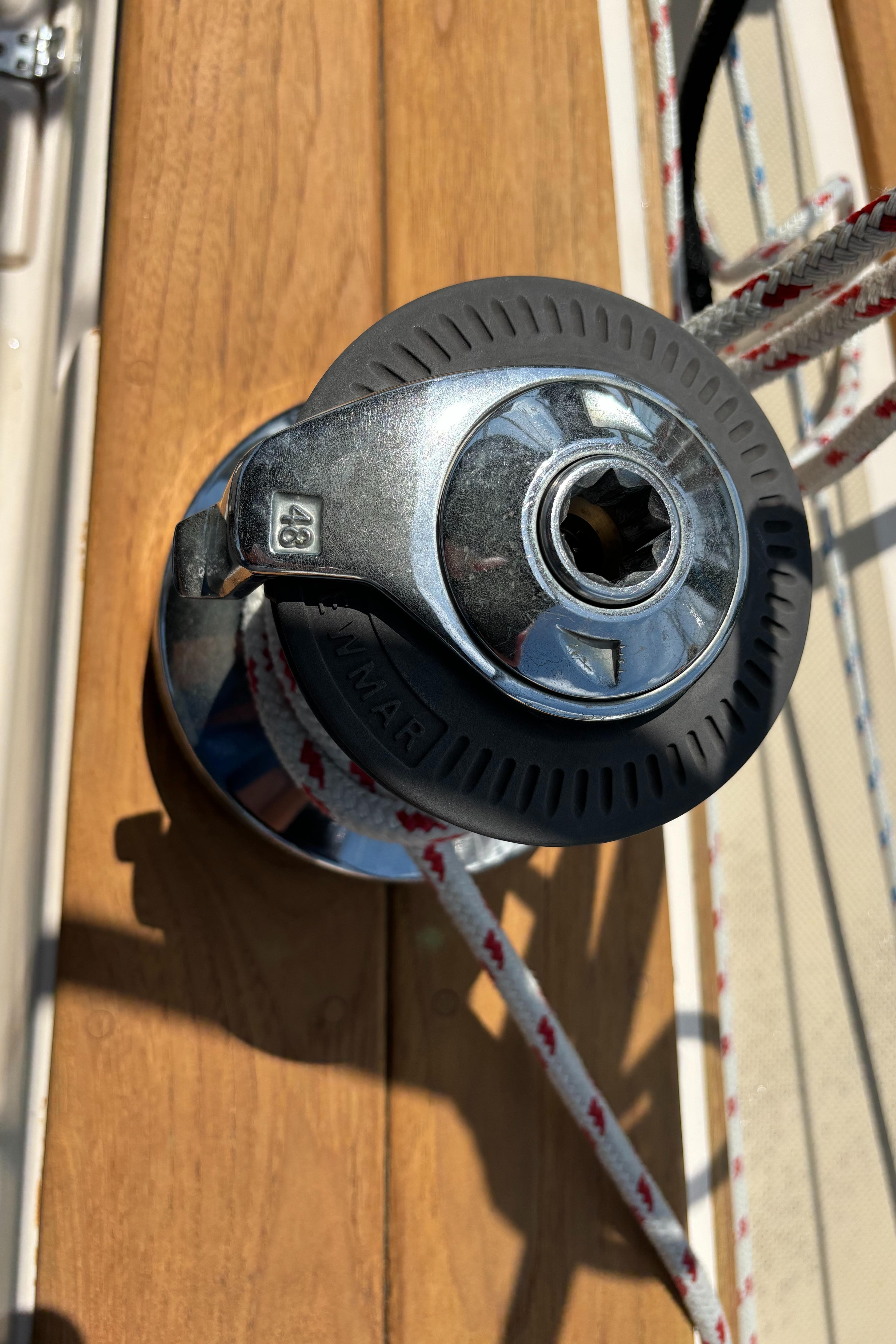 Winch on 1995 Island Packet 40 sailboat deck with rope.