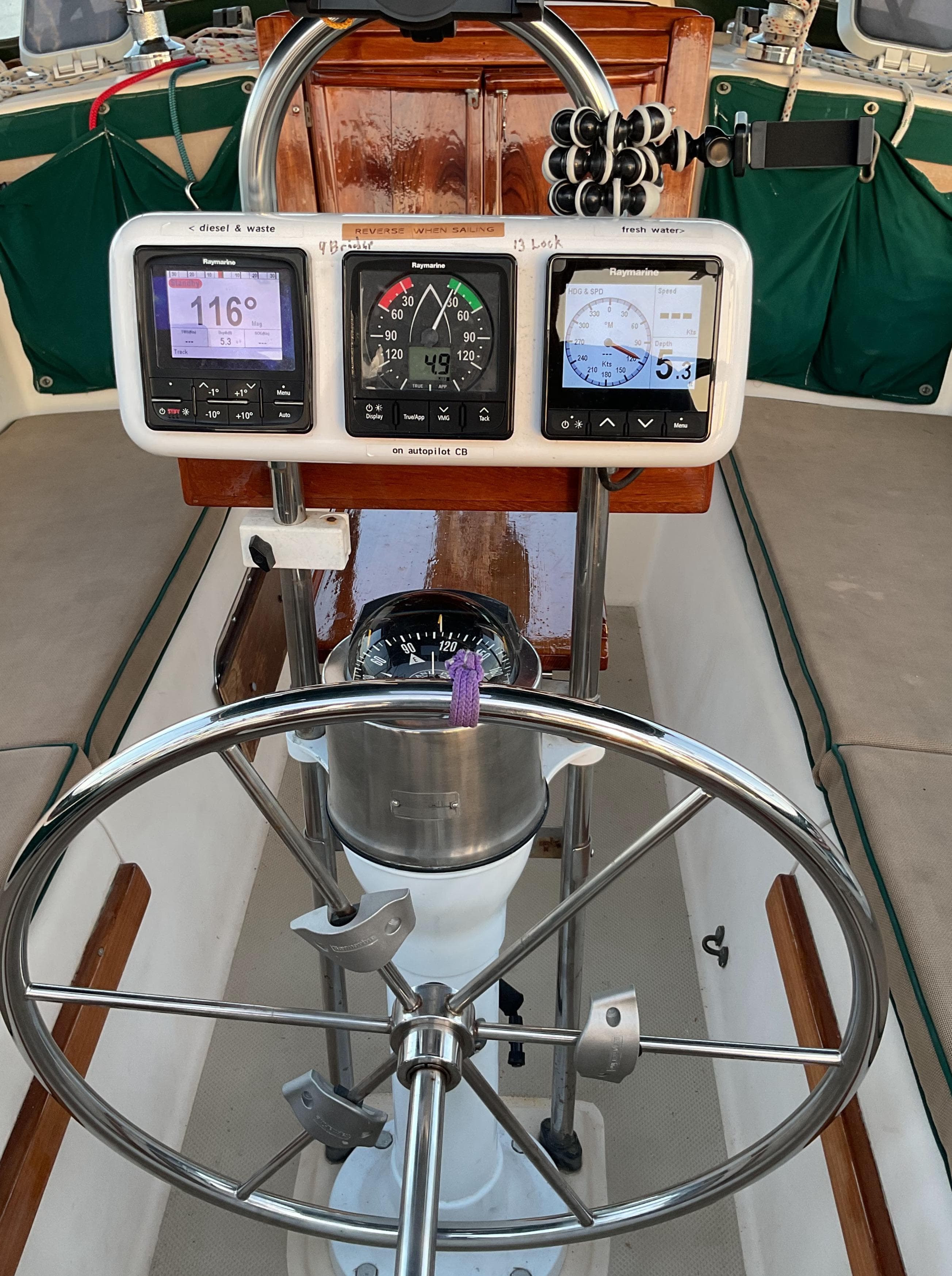 1990 Island Packet 32 sailboat cockpit with navigation instruments and steering wheel.