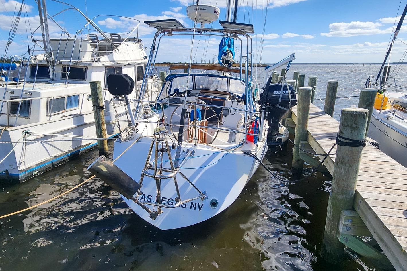 1980 Nordic 44 sailboat docked at marina under clear blue sky.