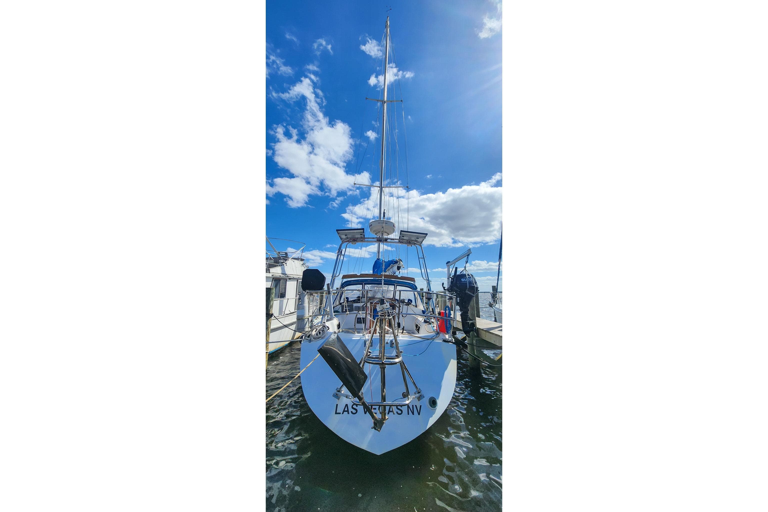 1980 Nordic 44 sailboat docked under a bright blue sky.