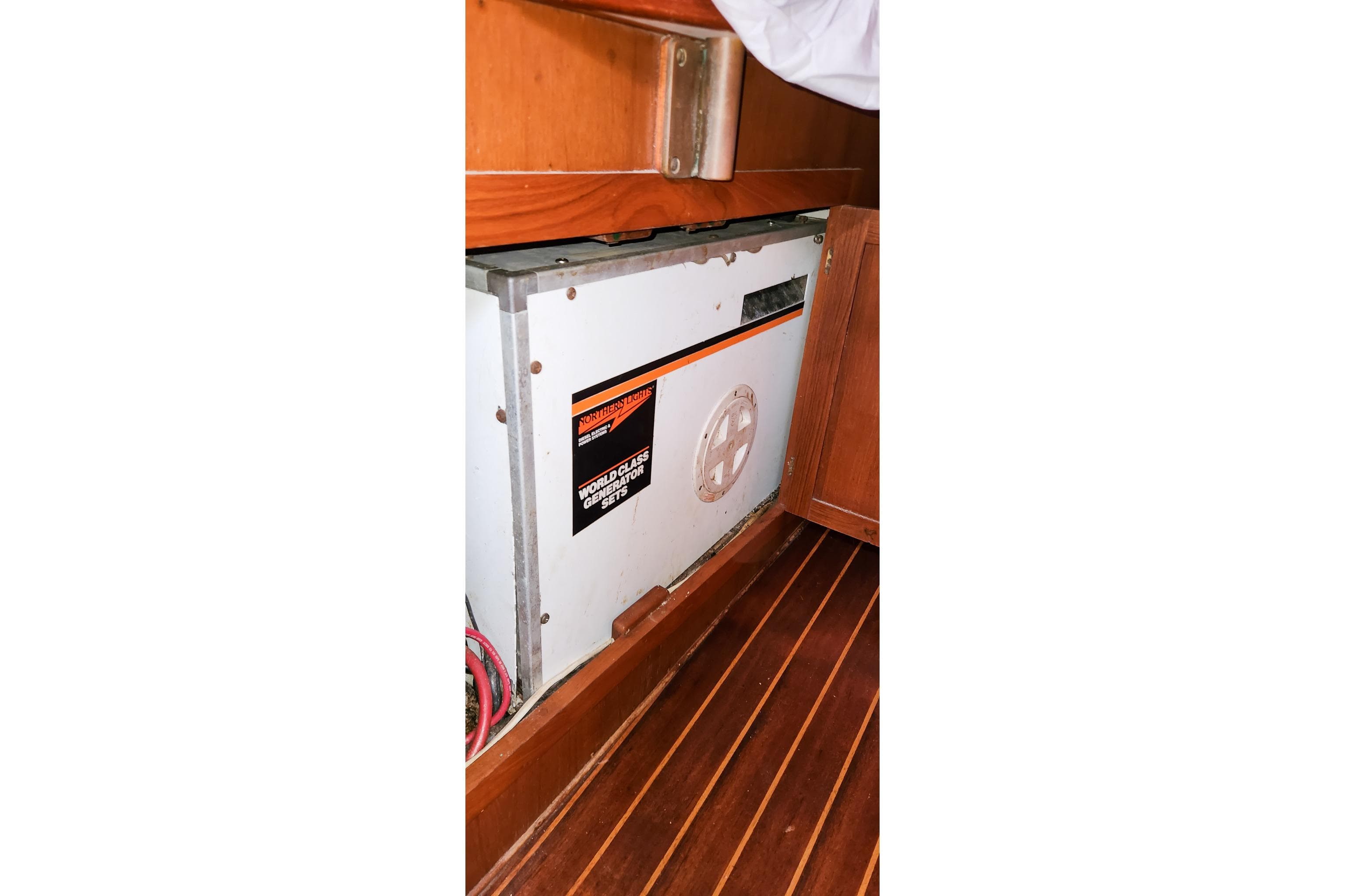 1980 Nordic 44 yacht interior with generator, wooden cabinetry, and flooring.