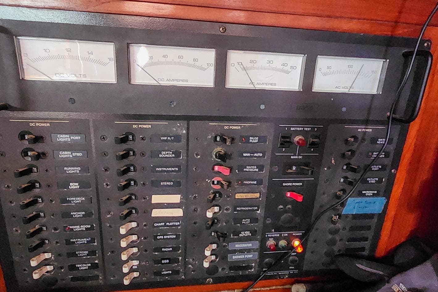 Electrical control panel on a 1980 Nordic 44 boat with gauges and switches.