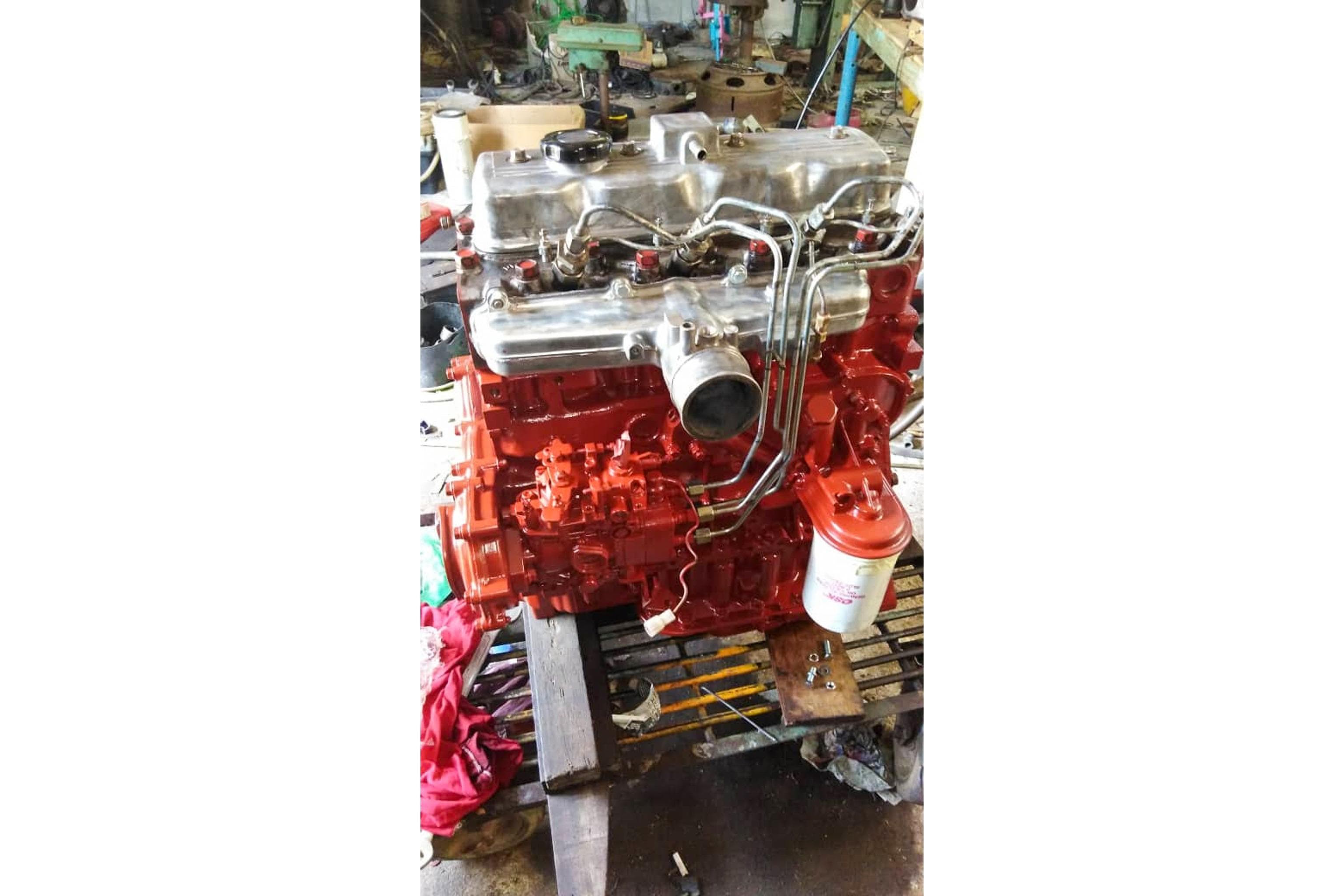 1980 Nordic 44 engine, red and silver, in a workshop setting.