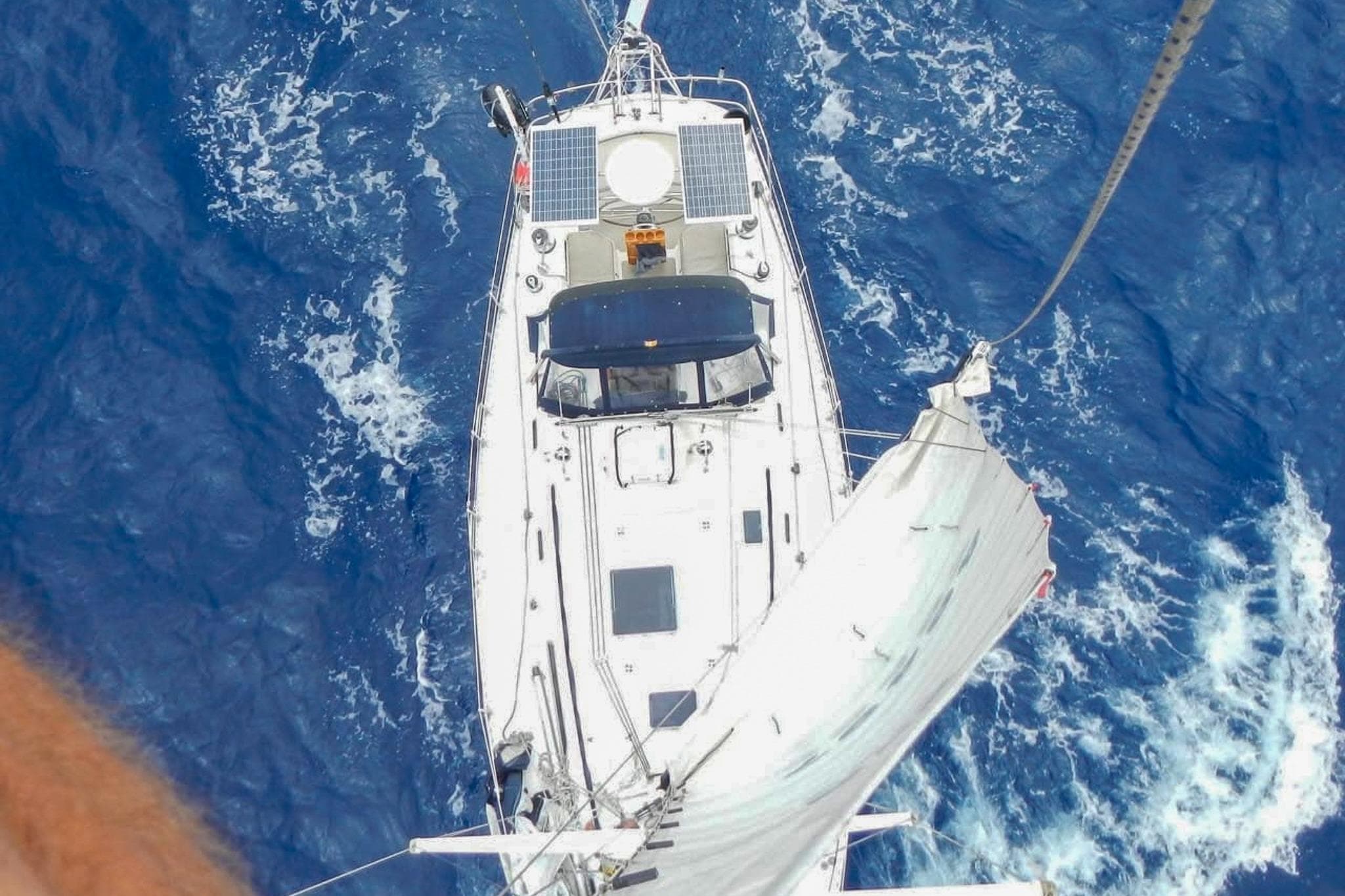 Aerial view of 1980 Nordic 44 sailboat navigating through deep blue ocean waters.