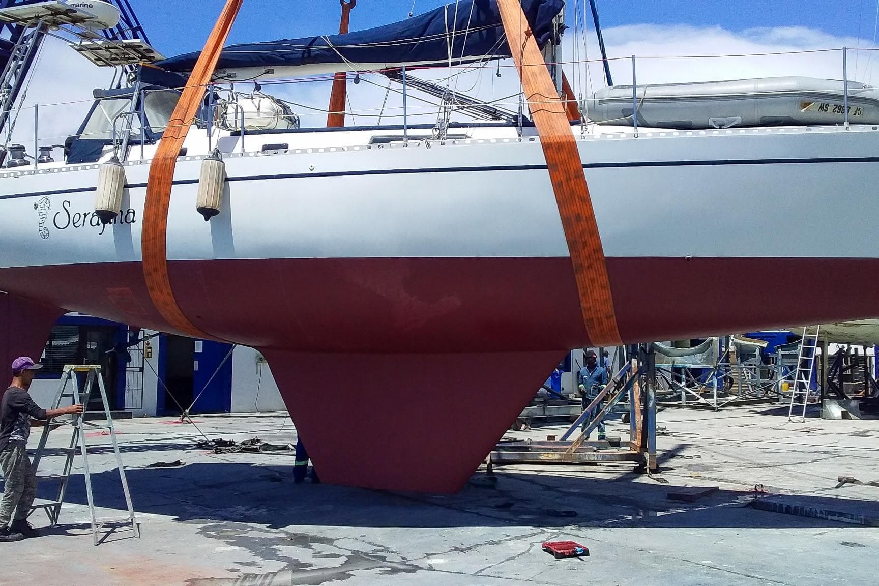 Sailboat Nordic 44 from 1980 in dry dock, undergoing maintenance with visible keel and straps.