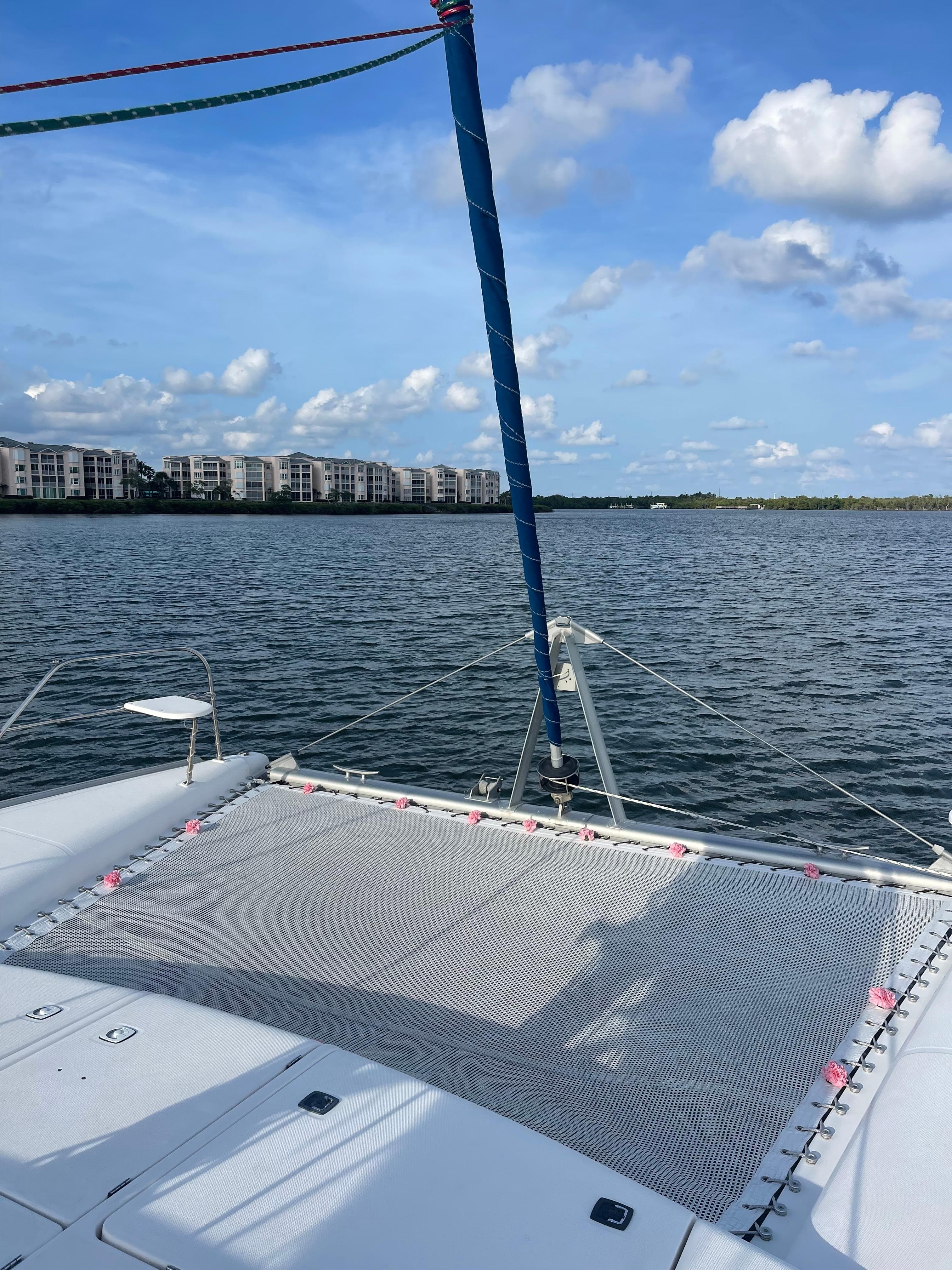 Leopard 40 catamaran on calm water with buildings in the background, 2006 model.