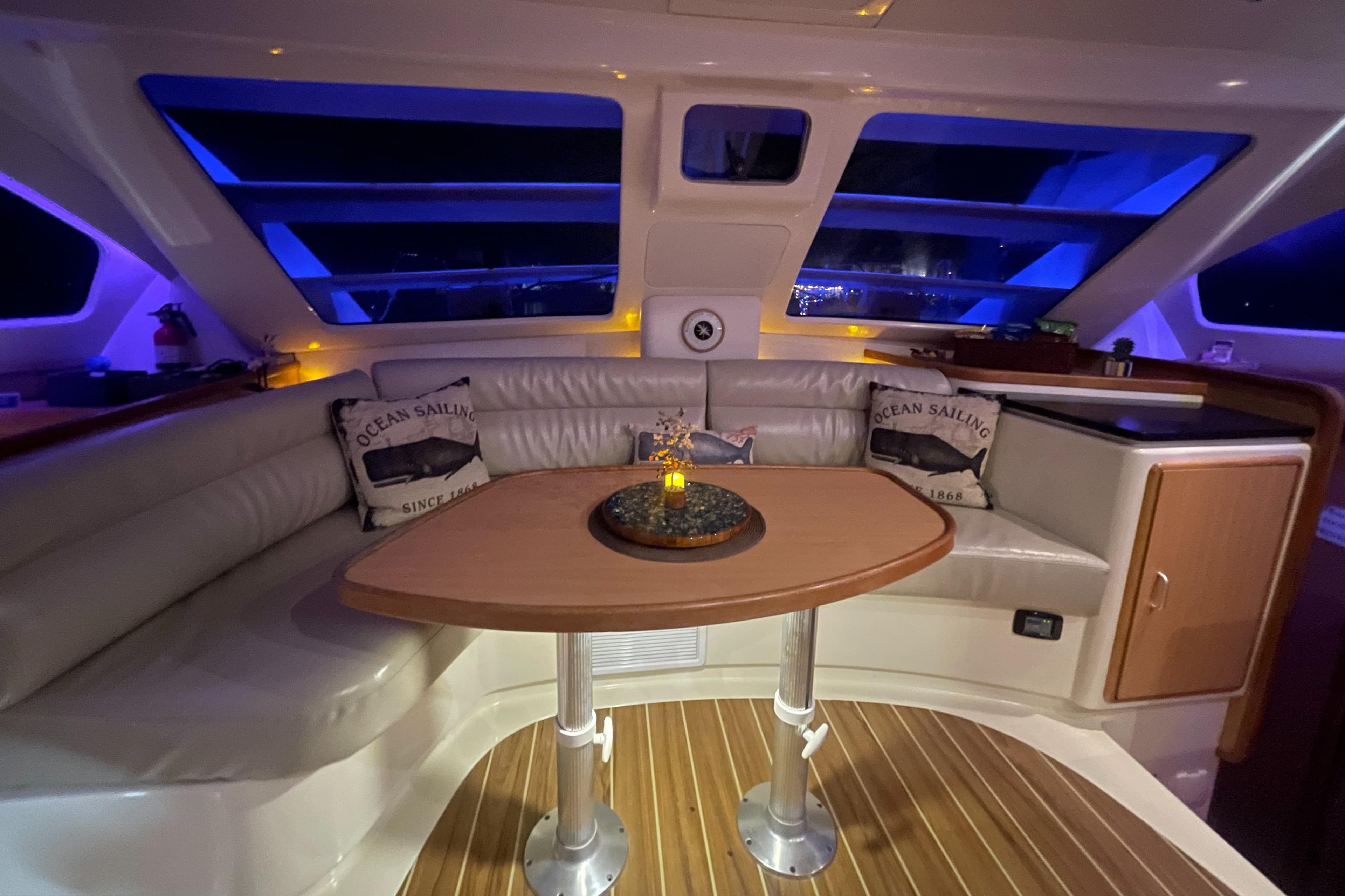 Luxurious interior of a 2006 Leopard 40 yacht with ambient lighting and comfortable seating.