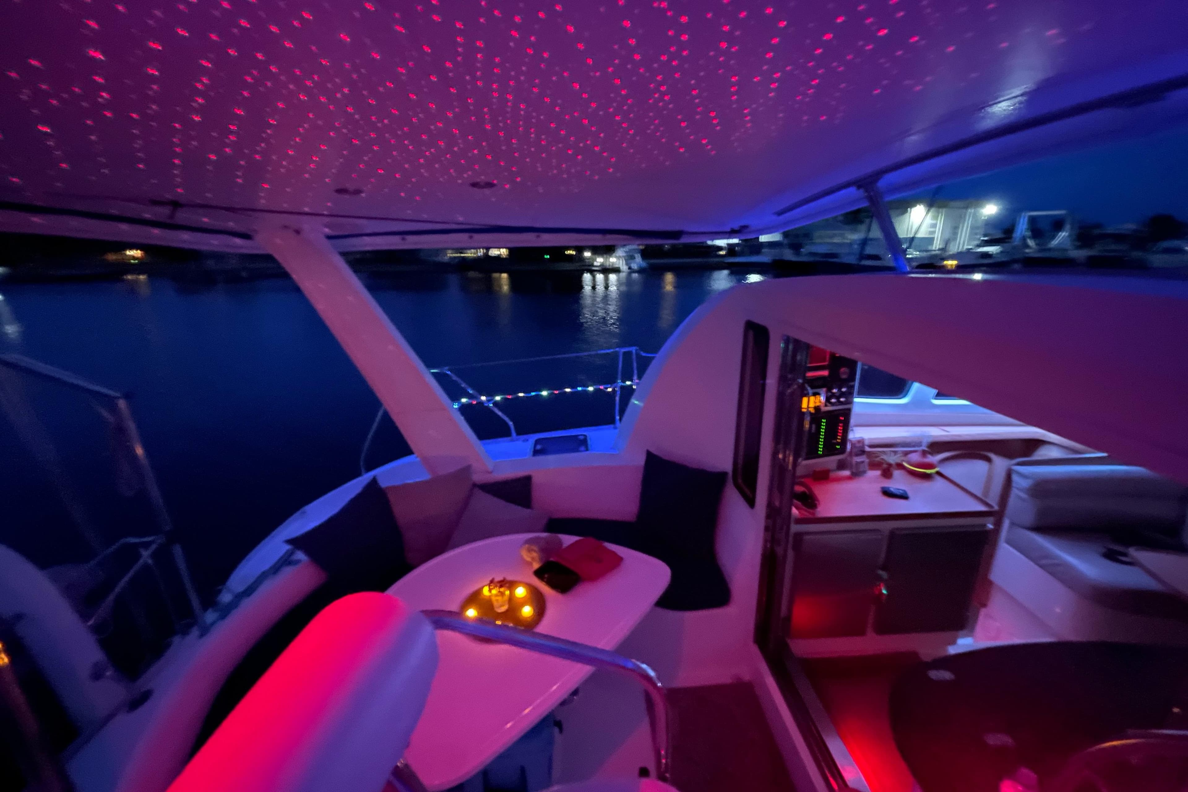 Leopard 40 yacht interior with ambient lighting, featuring a cozy seating area and night view.