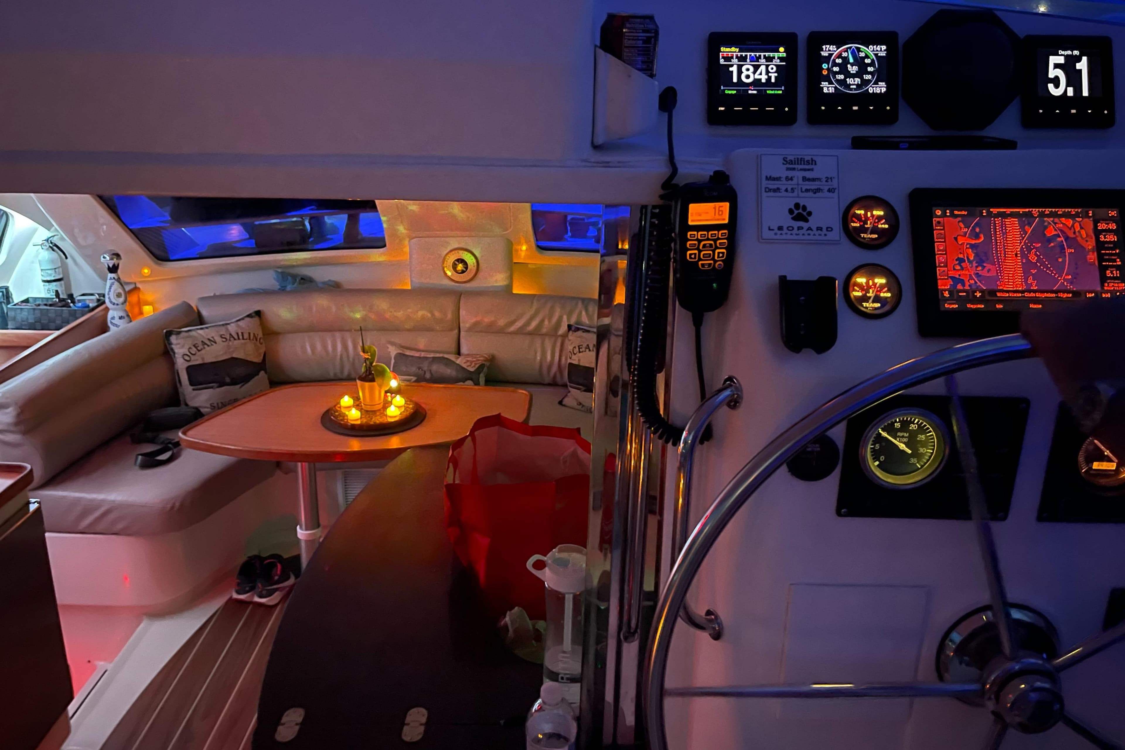 Cozy interior of a 2006 Leopard 40 yacht with navigation instruments and ambient lighting.