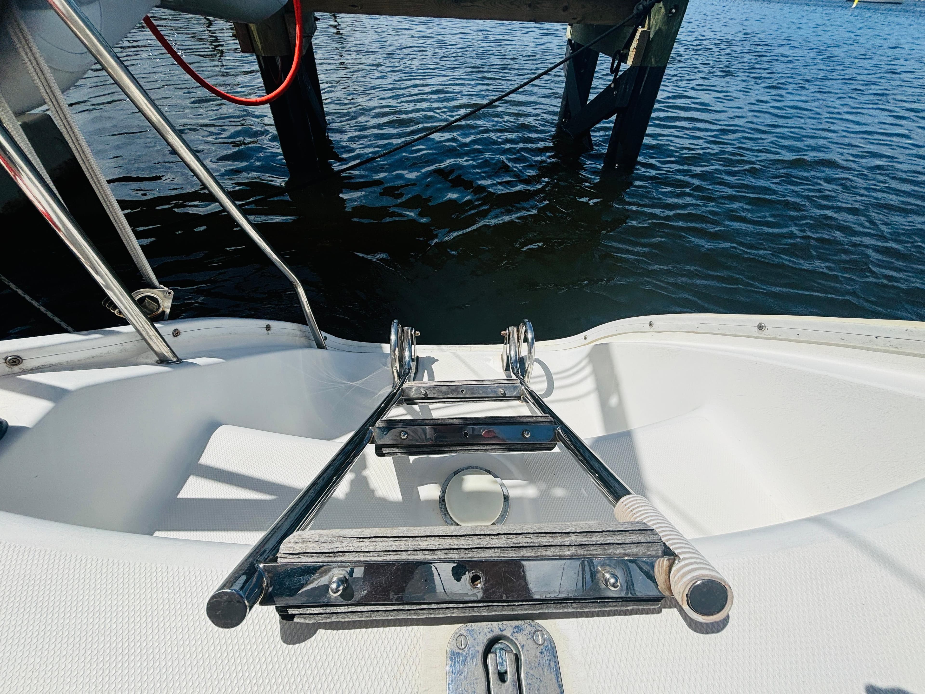 Leopard 40 catamaran deck with ladder, docked by the water, 2006 model.
