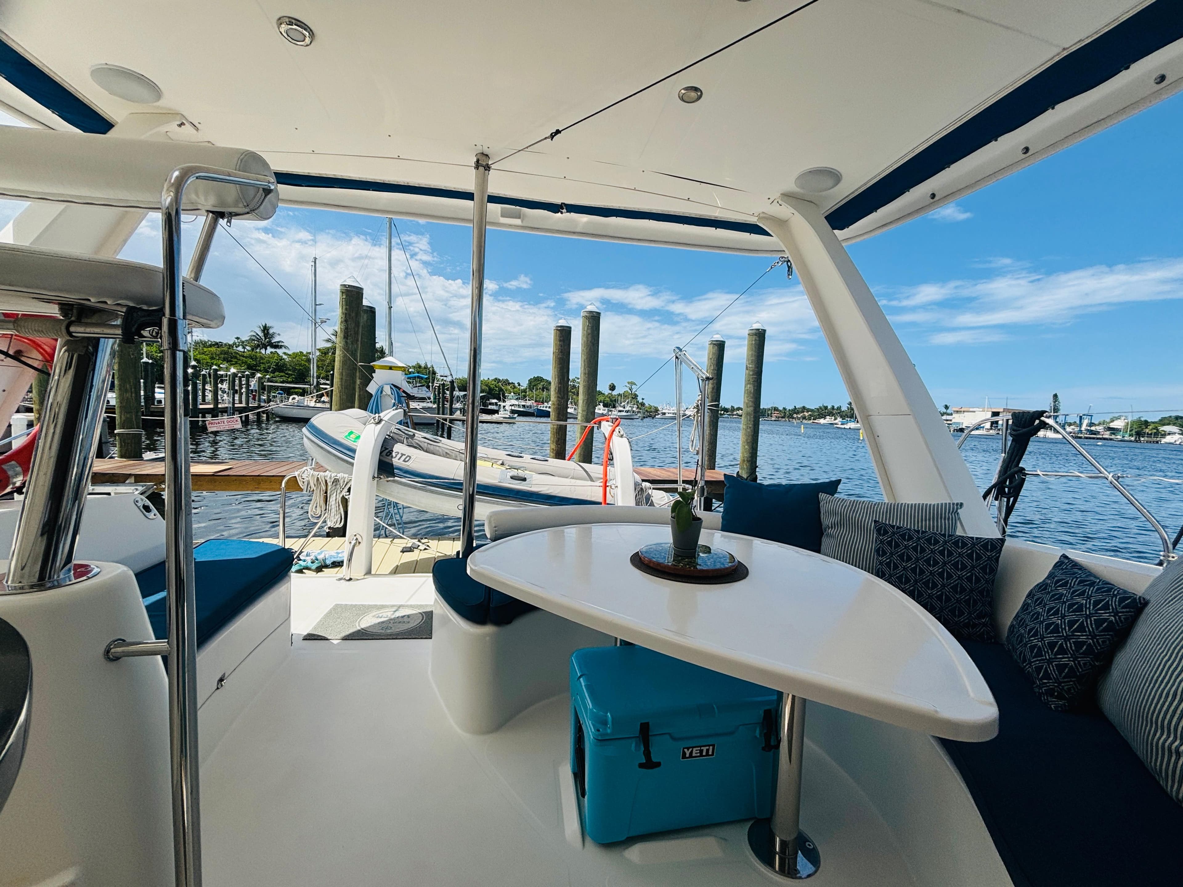 Leopard 40 catamaran interior with table, cushions, and scenic marina view, 2006 model.