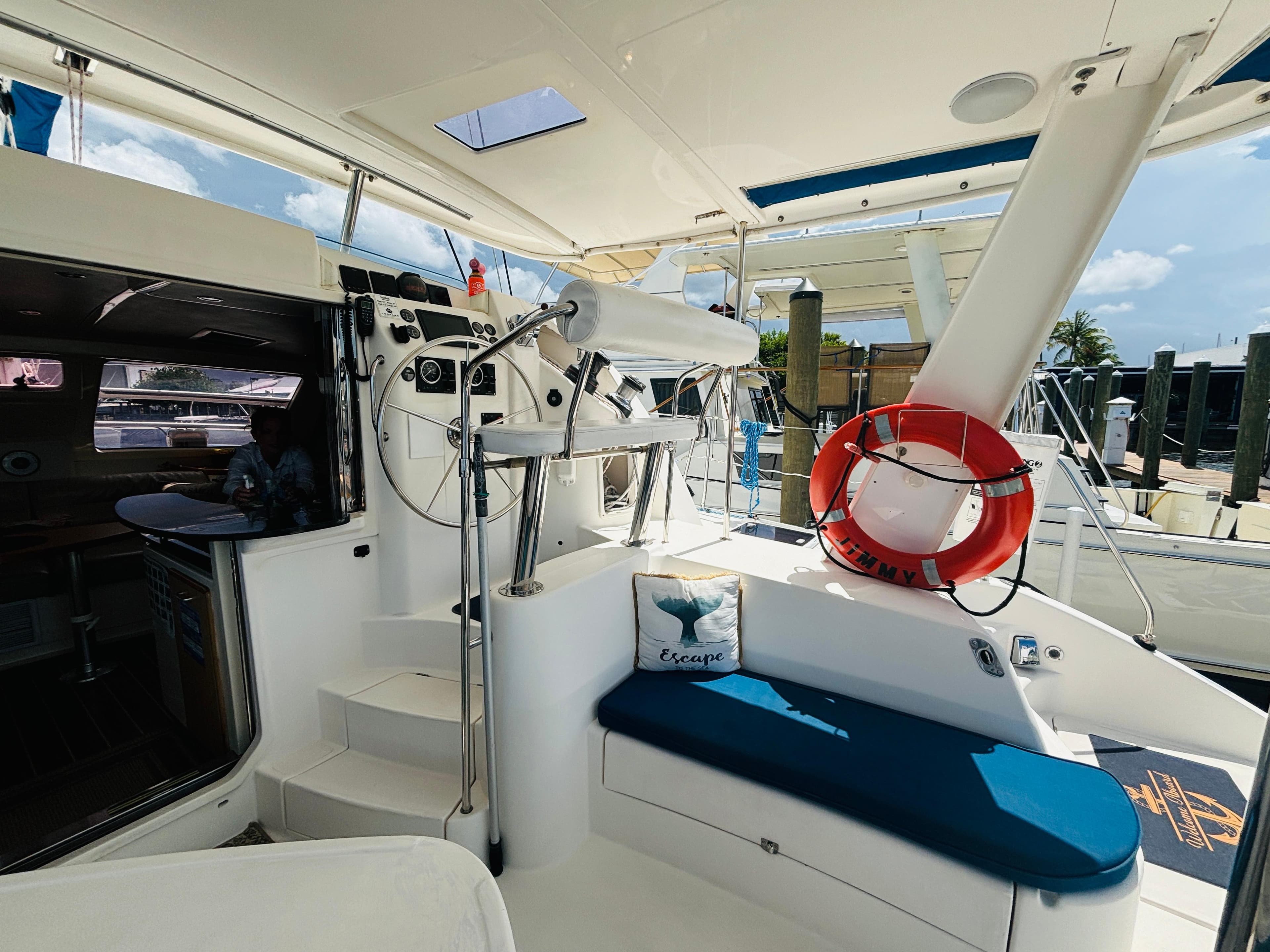 2006 Leopard 40 yacht cockpit with steering wheel, seating, and life preserver.