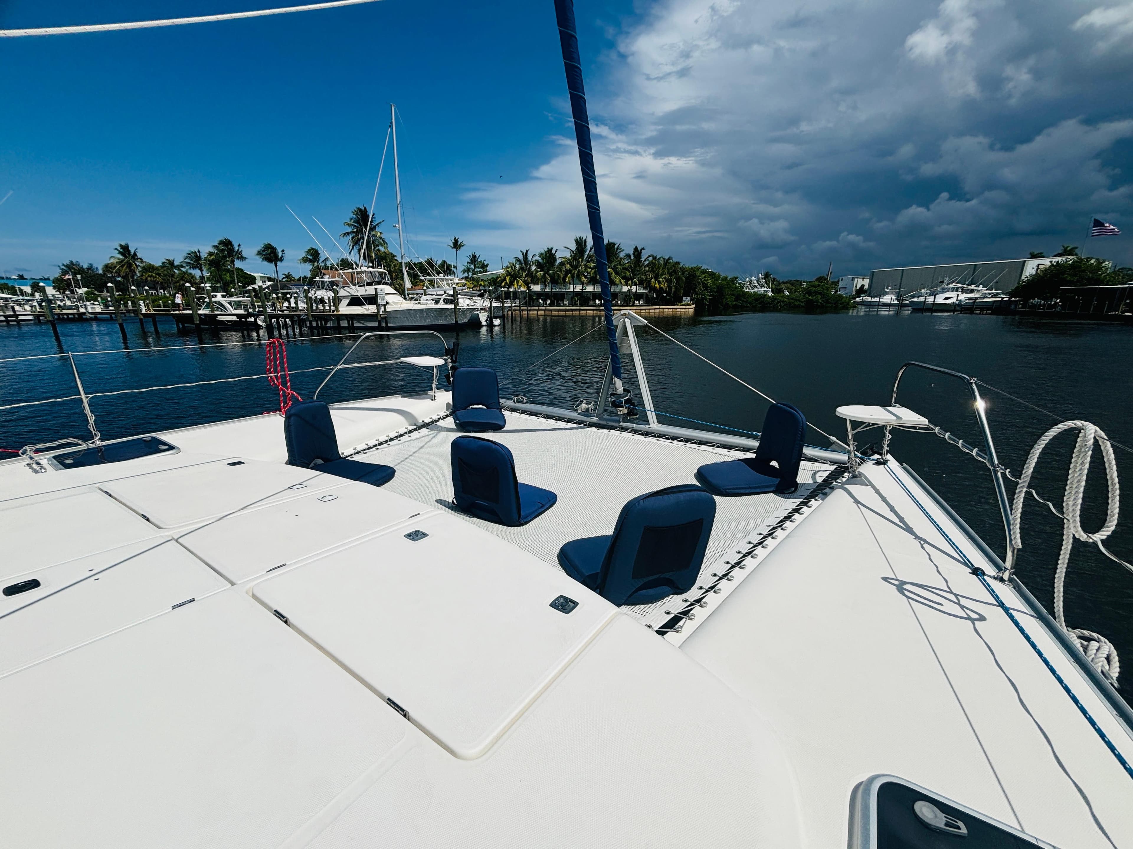 2006 Leopard 40 catamaran docked, featuring spacious deck and seating, under a partly cloudy sky.