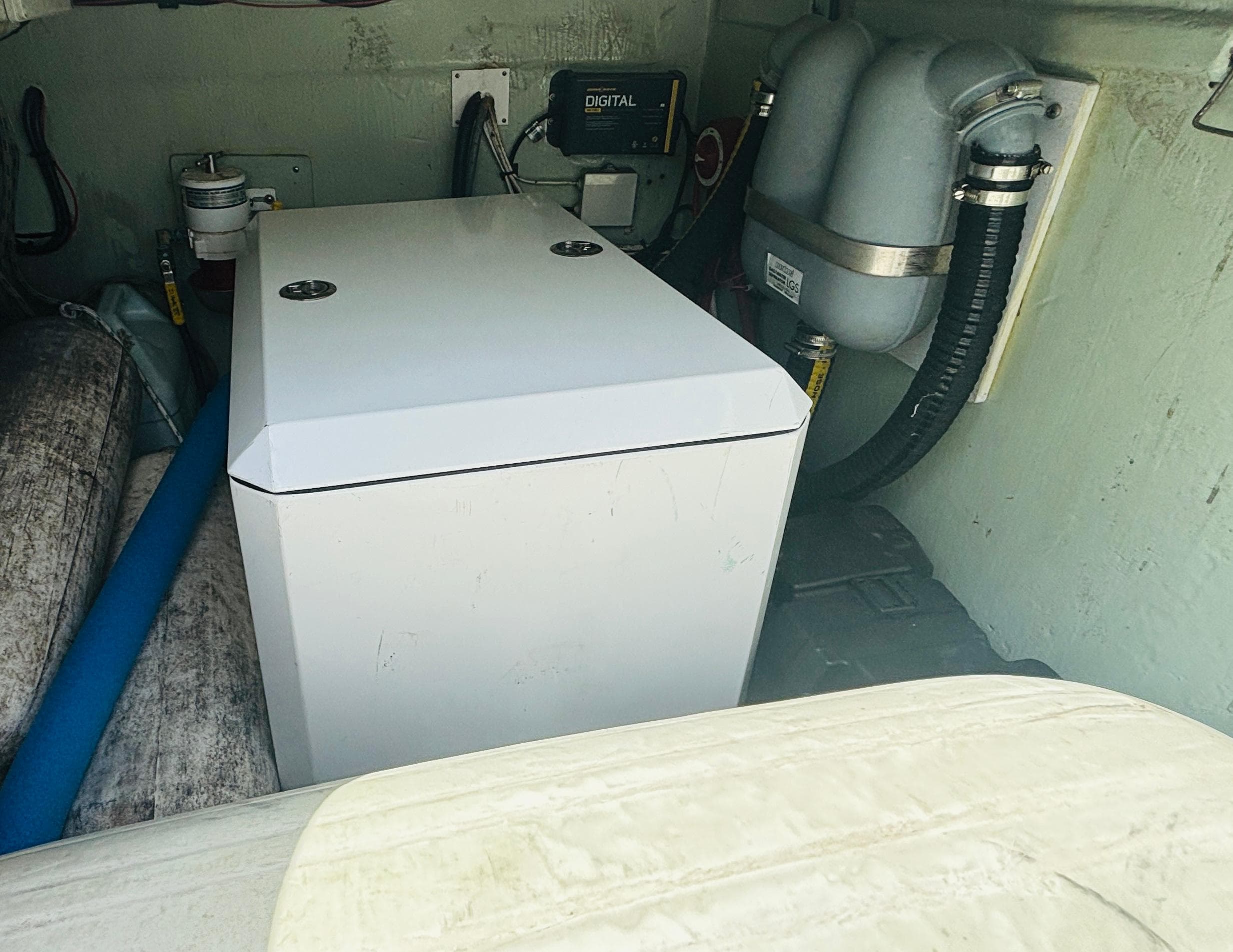 Engine compartment of a 2006 Leopard 40 catamaran, featuring mechanical components and storage.