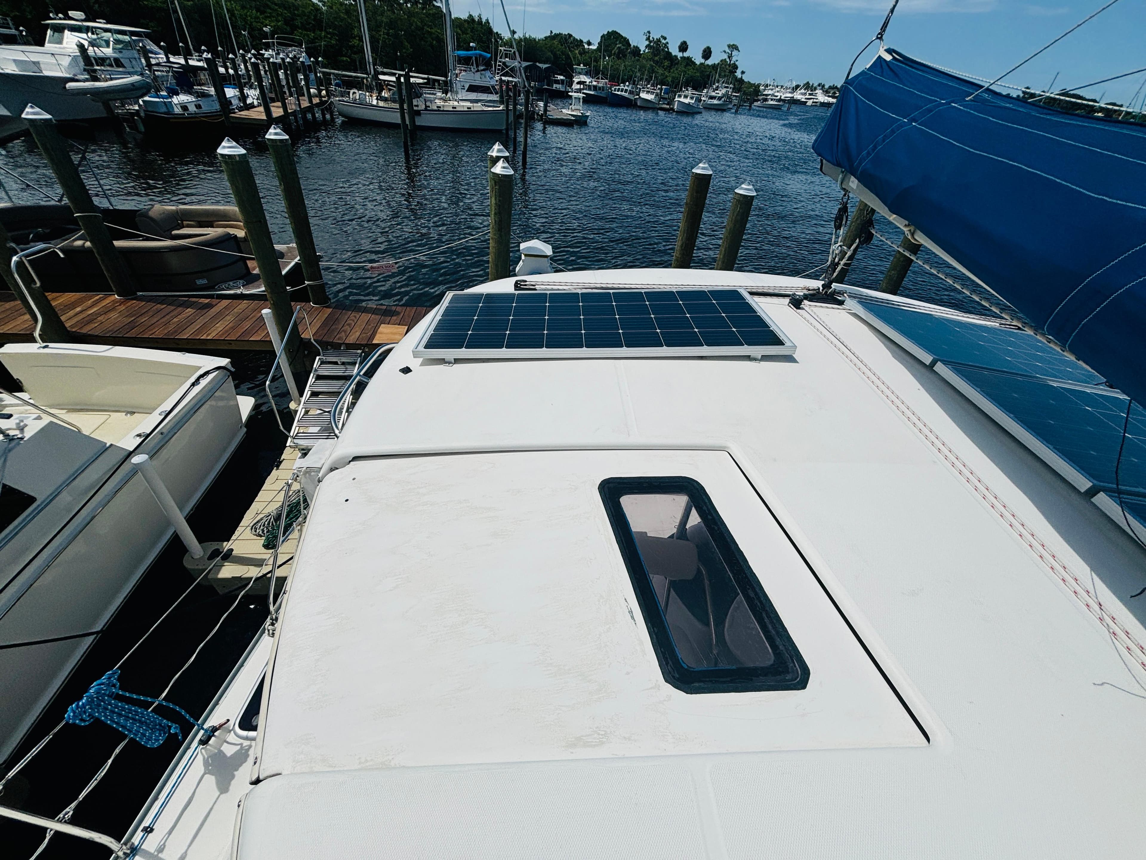 2006 Leopard 40 catamaran with solar panels docked at a marina.