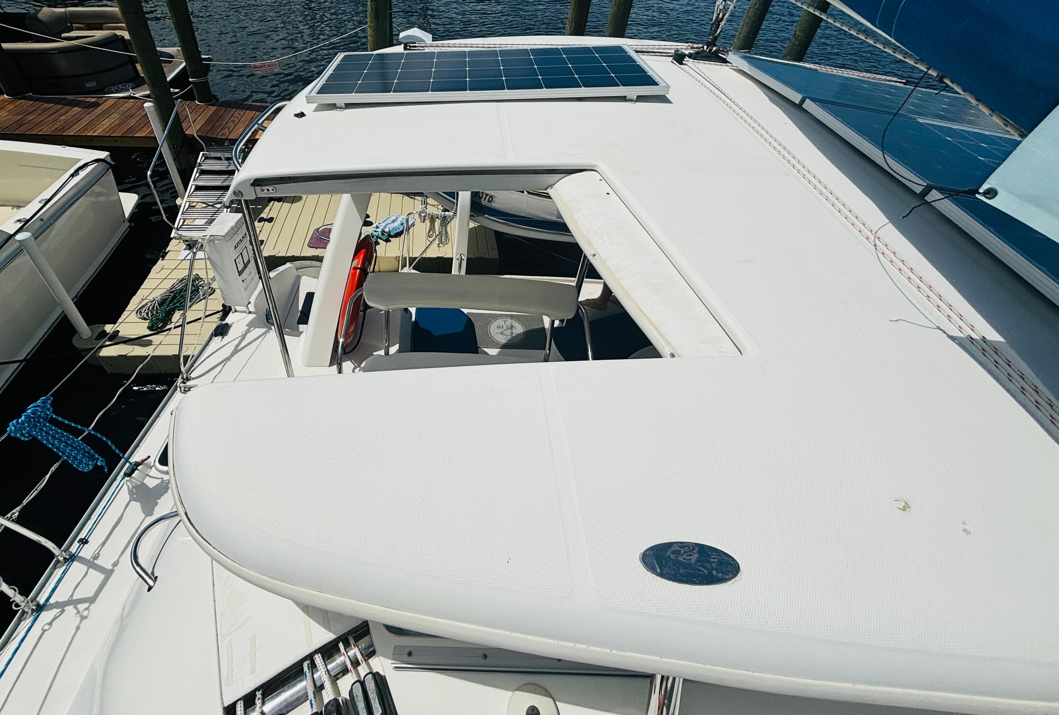 Leopard 40 catamaran, 2006 model, featuring solar panels and docked at a marina.