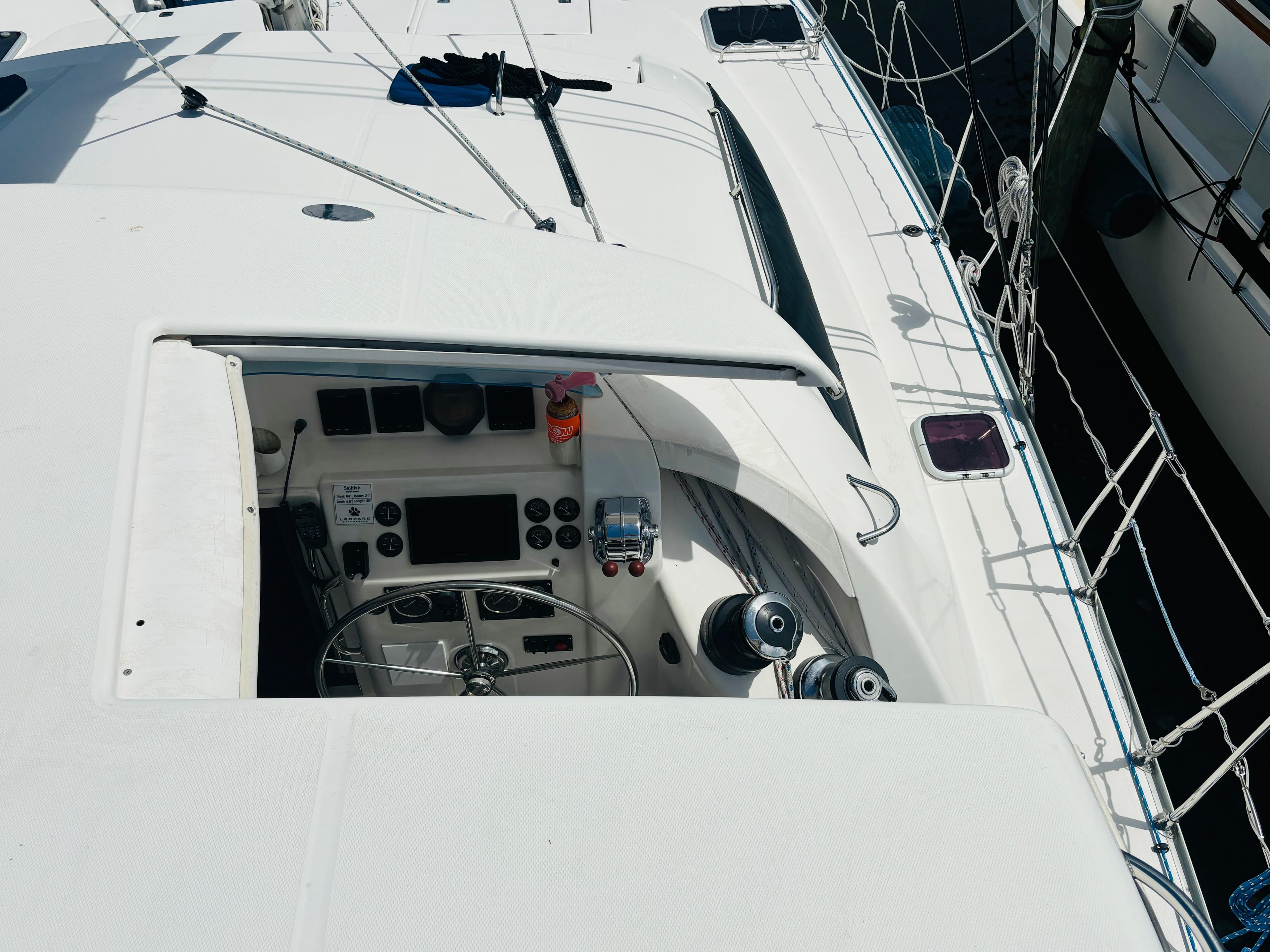 Cockpit of a 2006 Leopard 40 catamaran with steering wheel and navigation controls.