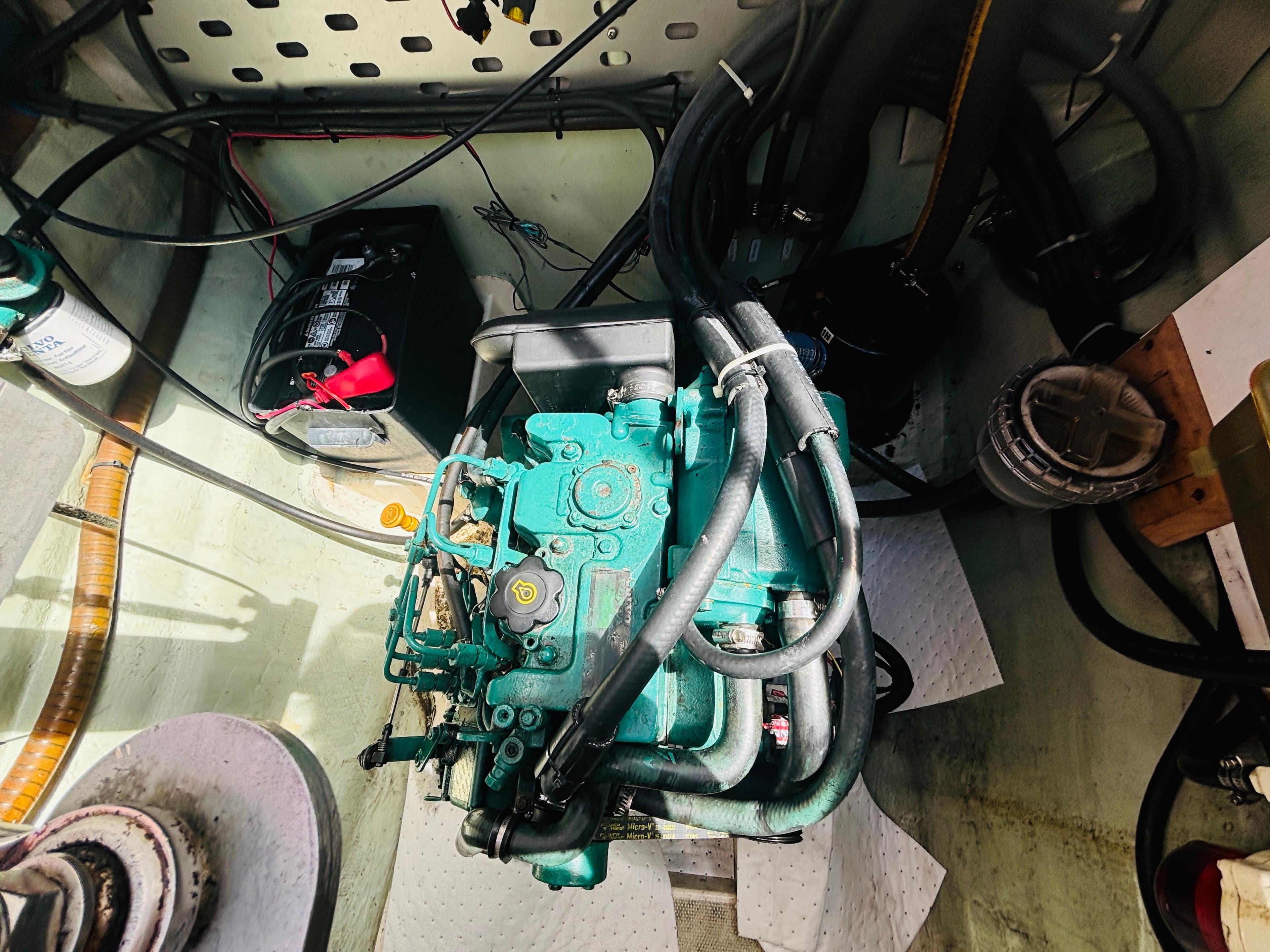 Engine compartment of a 2006 Leopard 40 catamaran, featuring a green marine engine.
