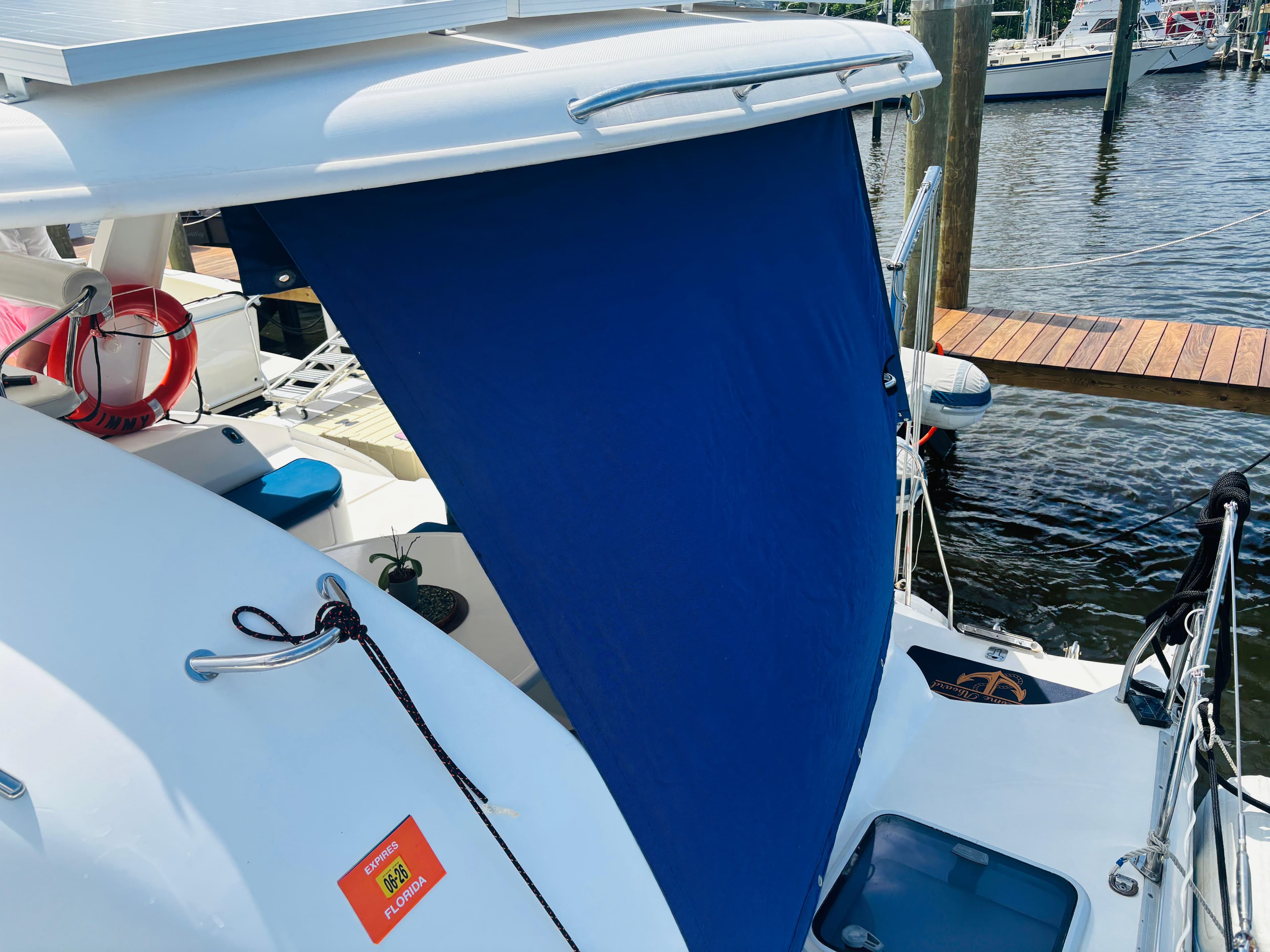 2006 Leopard 40 catamaran with blue sunshade docked at marina.